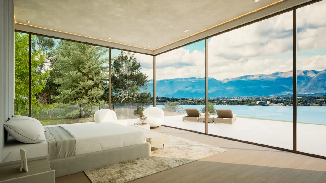 Bedroom with floor-to-ceiling glass opening to a terrace and lake view